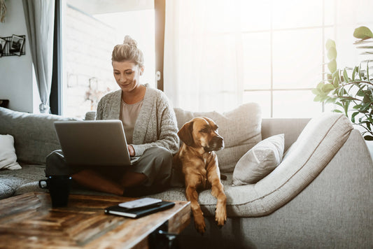 dog owner and her dog both sitting on the couch