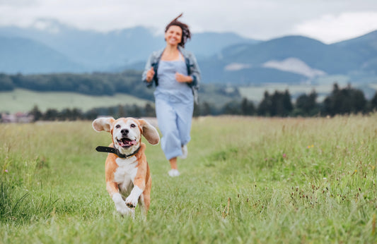 girl running to catch up with her dog
